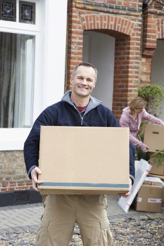 Professional house removalists assisting with loading furniture